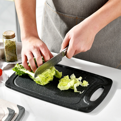 planche-a-decouper-personne-qui-coupe-de-la-salade